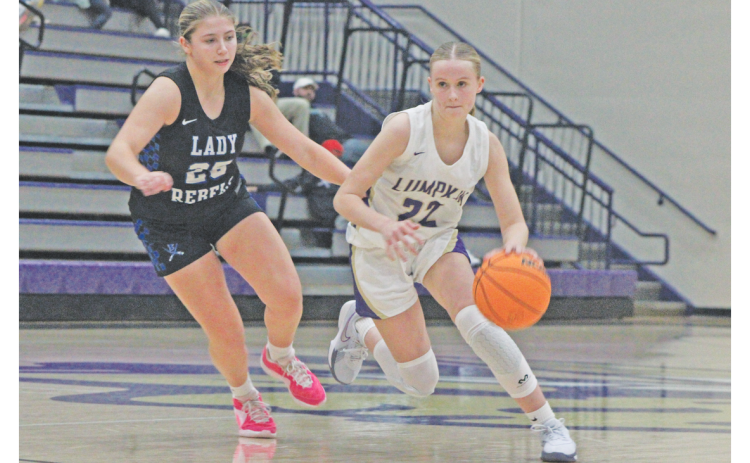 Lumpkin County’s Anna Davis plows her way down the court against the Rebels.