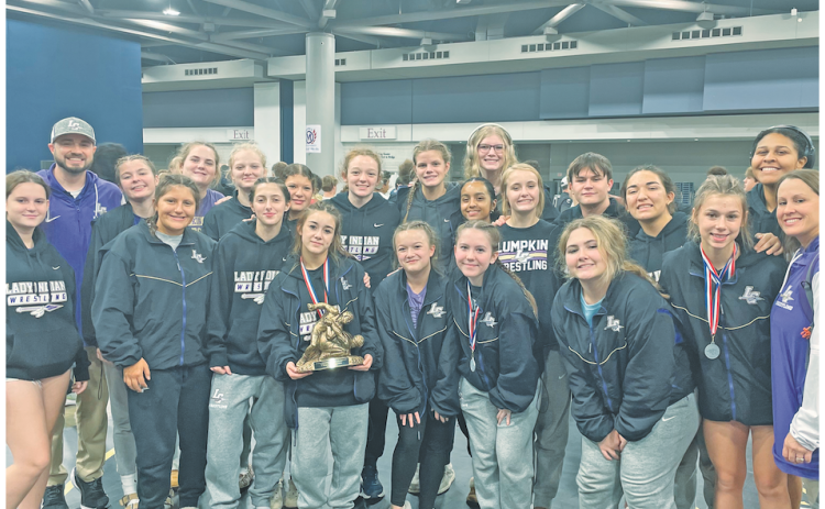 The Lumpkin County girls wrestling squad gathers following their first place performance in Alabama.