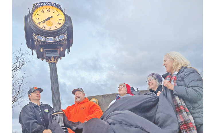 The recently donated downtown Rotary Club clock is officially unveiled Thursday morning with the assistance of, from left, Troy Armstrong, Justin Priest, past Rotary president Diane Bates, Mayor JoAnne Taylor and Rotary Assistant Governor Barbara Myers Mason.