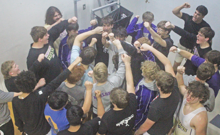 The Lumpkin County High School wrestling team breaks things down ahead of its finals match against Dawson.