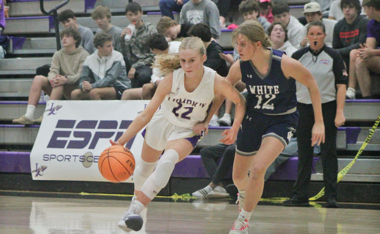 Lumpkin County player Anna Davis drives down the court for the Lady Indians.