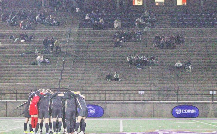The Lumpkin County High School boys soccer team takes a moment to focus before the game.