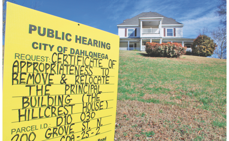 A sign on the lawn of the Hillcrest House notifies the public of a proposal to relocate the historic building. The structure is a well-known landmark to frequent passers-by on North Grove Street.