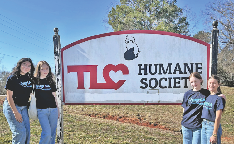 Lumpkin County High School sophomores (from left) Emma Rodriguez, Josie Tullis, Helana Tullis and Blakely Bell recently toured the Dahlonega TLC Humane Society as part of their HOSA student service project.