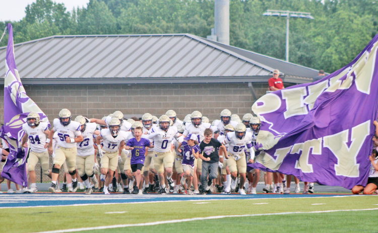 The Lumpkin County High School football team storms the field ahead of their Spring Game.