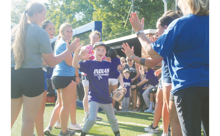 Local athlete Tommy England storms out of the dugout and onto the field ahead of the Heroes game.
