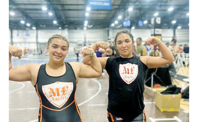 Natalie (left) and Mattie Mendoza showed their strength at the NHSCA National Duals meet.