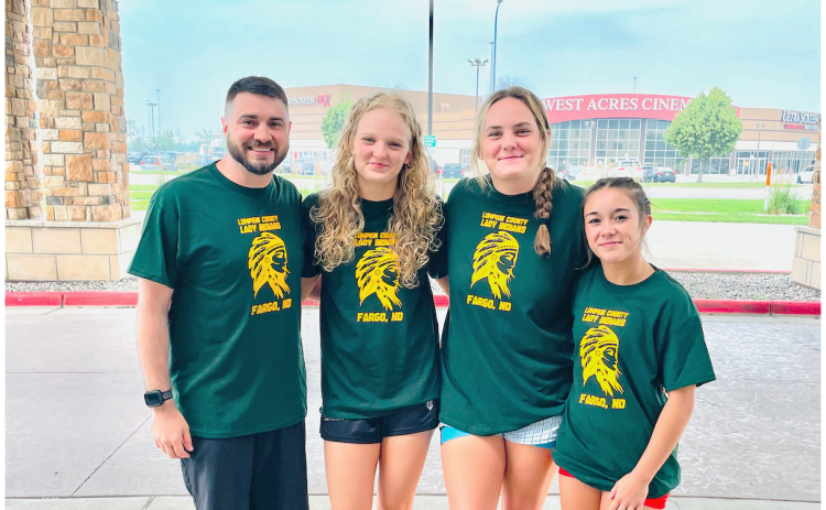 Pictured, from left, Lumpkin wrestling coach Scott DeGraff, Greta Garbuzovas, Faith Jones and Cadence Grulla gather outside the Fargo Dome in North Dakota.