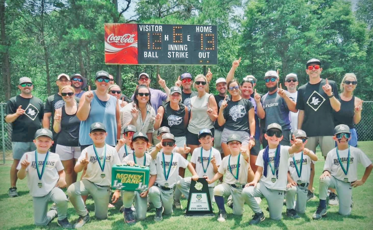 The Lumpkin County 8U team, backed by their coaches and parents, celebrate the State Championship victory.
