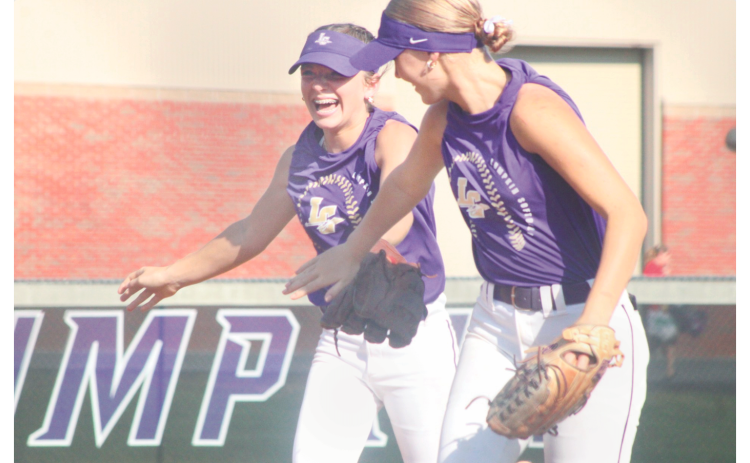 Lumpkin County High School softball players Maddox Henderson (left) and  Abi Kate Webb celebrate a great play at last week's summer game.