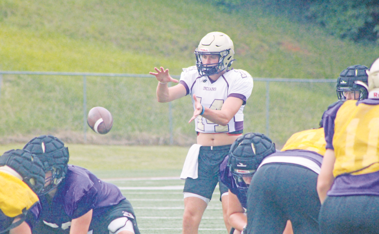 Lumpkin County’s Mason Hester takes a snap during last week’s practice at LCHS.