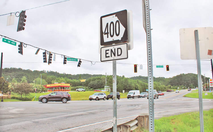 A road sign marking the northern terminus of Highway 400 stands on the future site of a dedicated right turn lane. The Georgia Department of Transportation is expected to break ground on the project later this year to ease congestion at the busy intersection.