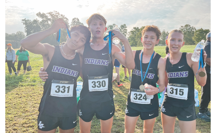 Pictured (from left): Paulo Ramirez, Nickson McGillivray, Bowen Aiken and Ari Cook celebrate the cross country team’s recent race accomplishments.