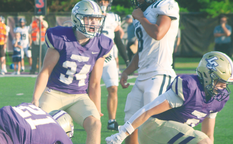 Caleb Wendl celebrates a tackle for a loss of yardage against the Spartans.