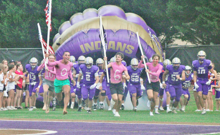 The Indians storm the field ahead of their showdown against Cherokee Bluff in the season opener.