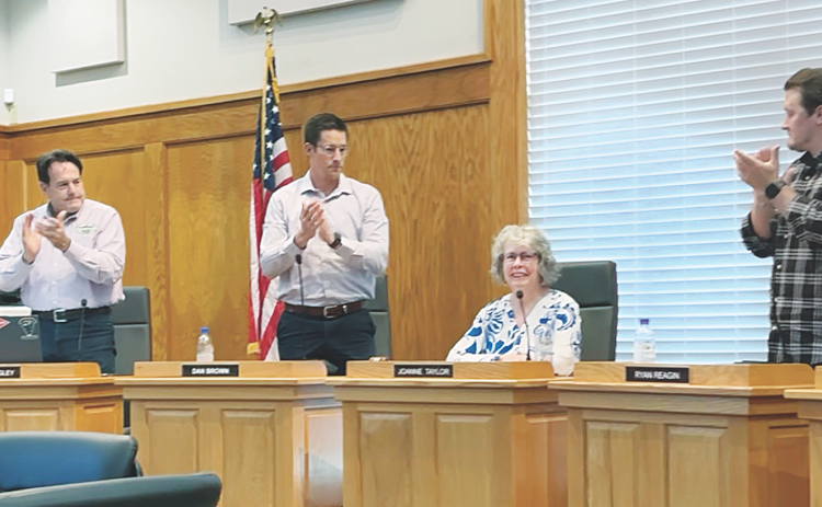 Mayor JoAnne Taylor receives an appreciative standing ovation from City Council members and attendees at last Monday's meeting.