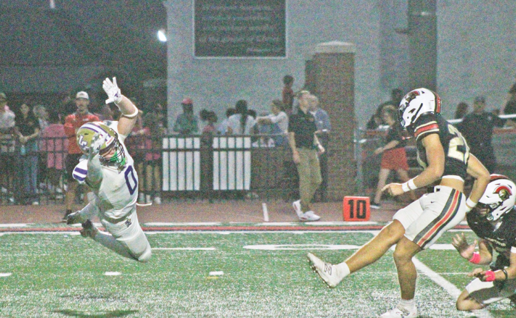 Wolf Harbin attempts to block a field goal against the Spartans.