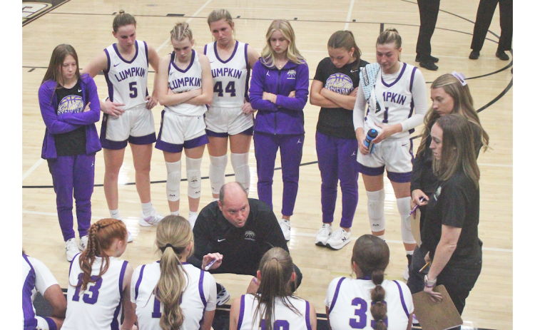 Lumpkin County Girls Basketball head coach Brian Richerson talks strategy with his team.