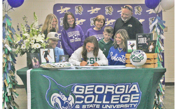 Rileigh Raftelis signs her commitment to attend Georgia College as a soccer player.
