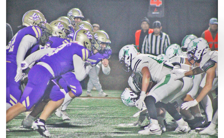 Lumpkin County’s defense charges at the Pickens offensive line during a fourth down play in last week’s matchup.