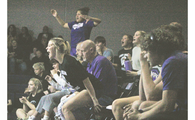 Gaby Luper and her Lumpkin teammates cheer on the squad from the sideline.