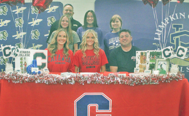 Lumpkin County soccer senior standout Kaitlyn Johnson celebrates her college signing with her family and coaches.