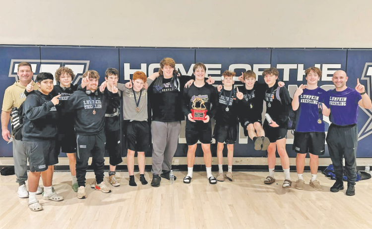 The Lumpkin County boys wrestling team celebrates its first place win at the Spartan Slam.