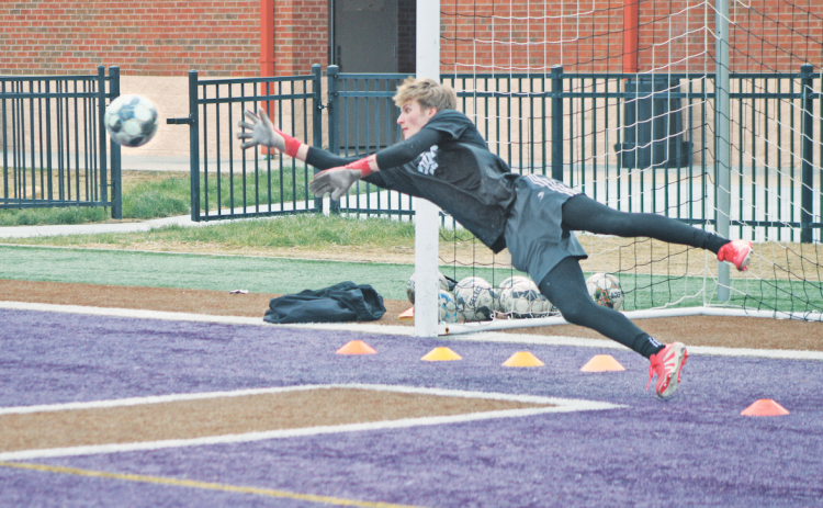 Lumpkin County goalie Chance Sprague dives for a block durning a practice drill.