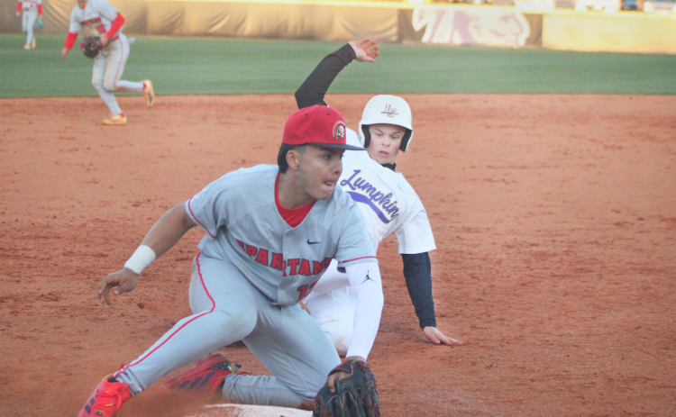 Logan Hamrick slides into third as a GAC defender blocks the bag.
