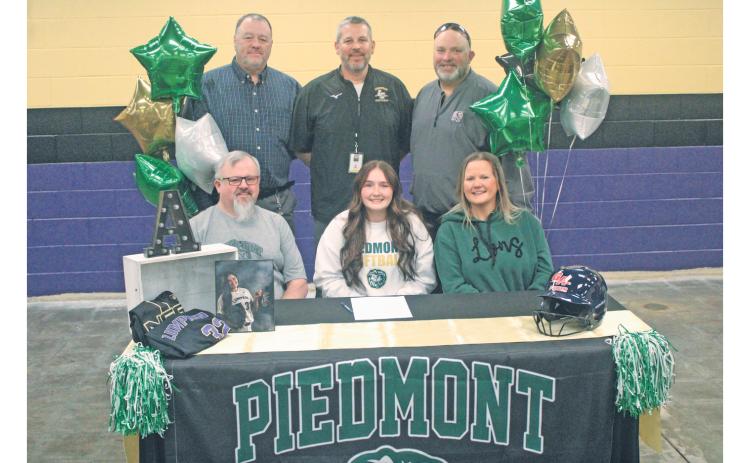 Ava Estes celebrates her college commitment with her coaches and family.