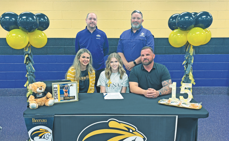 Lumpkin basketball player Alayna Lindley celebrates her college signing with her coaches and family.