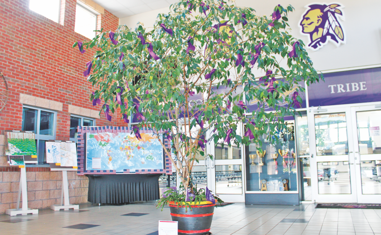 To commemorate Military Child Month this April, Lumpkin County High school adorned their ficus tree in the front lobby with a purple ribbon for each of the school’s 57 military-connected students. The ribbons were made by middle school students during the recent LCMS Community Connect Day.