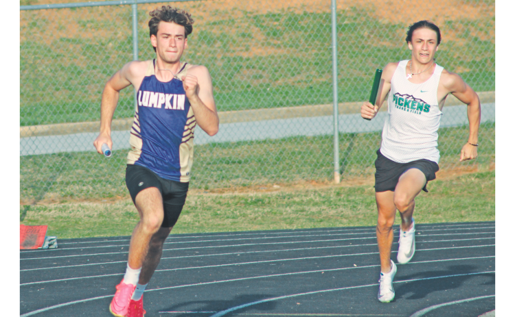 Jeb Jackson races his way to the hand-off in the boy’s relay race at White County.