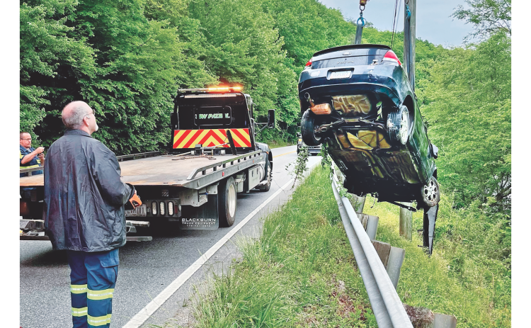 No major injuries were reported after the driver of a Ford Focus jumped the guardrail on Highway 60 and landed in the Chestatee River on Saturday morning. But it still made for a tricky towing job as, from left, Eddie Nicholson and Keith Rider assist Travis Glover, not pictured, of Travis Tow Patrol.