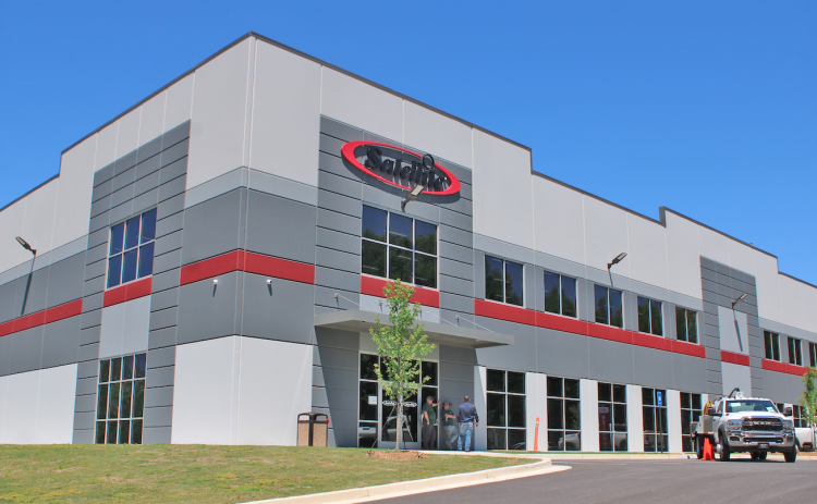 Satellite Industries held a ribbon cutting last week to celebrate its new 172,000 square foot manufacturing and distribution center, located on Fannie Russell Road in Lumpkin County.
