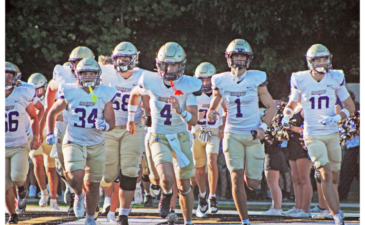 Starting quarterback Kolson Howell leads the Indians onto the field during their Spring Game at East Hall.