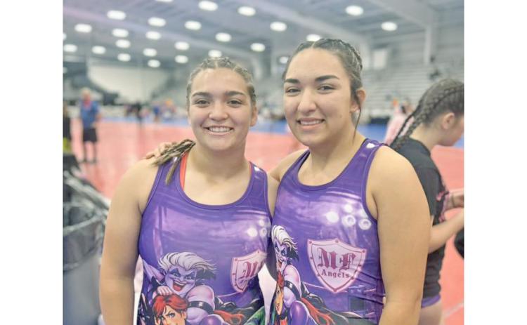Lumpkin County wrestlers Natalie (left) and Mathiel Mendoza share a fun moment ahead of one of their matches.