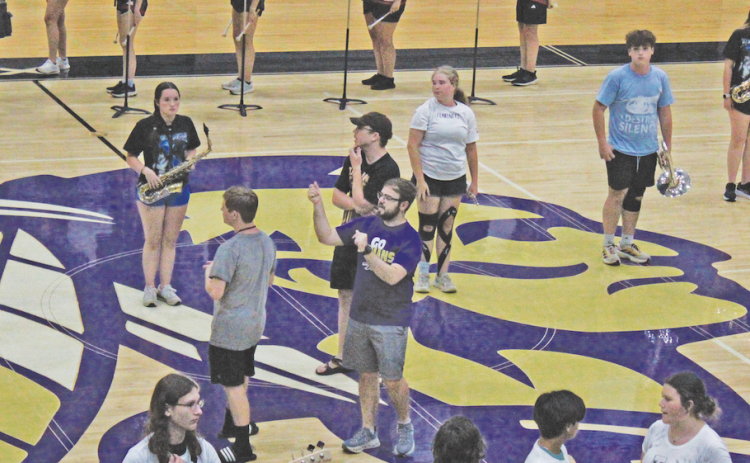 Band Director Corey Jackson talks his students through the routine before the recent early preview of this year’s new band.