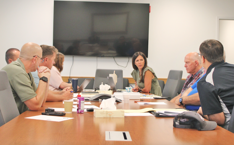 Lumpkin County Finance Directory Abby Branan (center) speaks to the Board of Commissioners during an August 7 special called meeting. Ultimately, the Board settled on a scaled-back 2027 budget of $34,674,700 with a full rollback of the local millage rate used to calculate real estate property taxes.