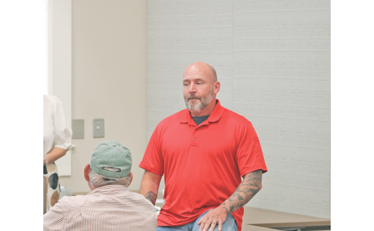 Officer Matthew Cook speaks about his use of the Flock system as an employee of the Gainesville Police Department during a townhall-style meeting hosted by Citizens for a Free Lumpkin.