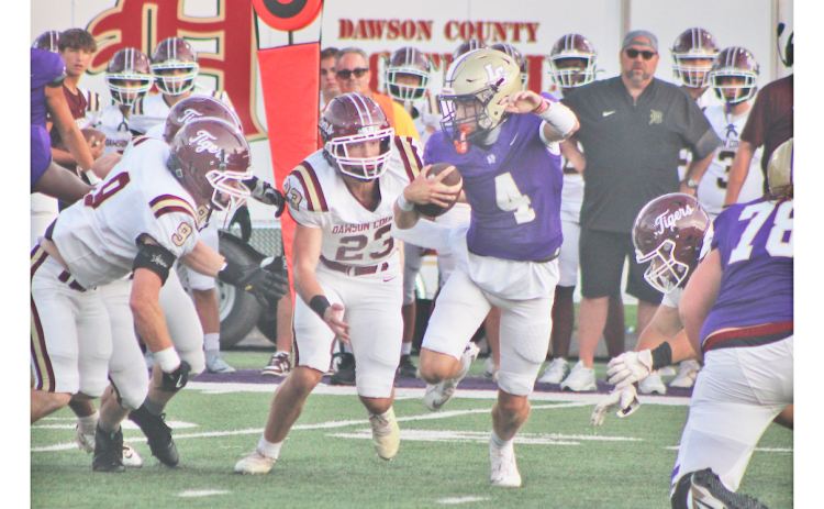 Junior quarterback Kolson Howell scrambles for extra yards against the Tigers during Friday night’s season opener.