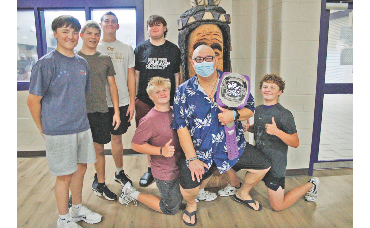 Josh Passmore gathers for a photo with some of his former athletes.