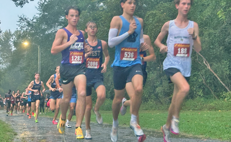 Lumpkin County’s Witt Windham (left) keeps pace with the leaders before sprinting away for the win.