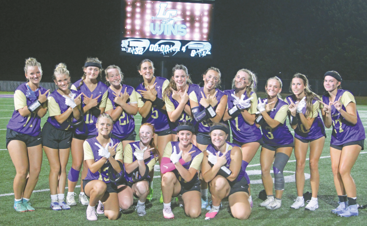 The Lady Indians celebrate the varsity flag football team’s first-ever victory.