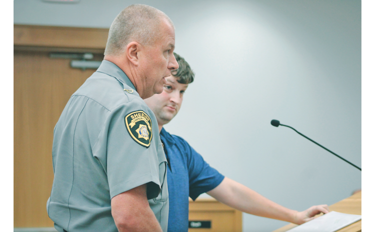 Lumpkin County Sheriff Stacy Jarrard reveals new efforts to regulate the Flock License Plate Reader system during a recent Board of Commissioners meeting, as surveillance opponent Robbie Ward looks on.