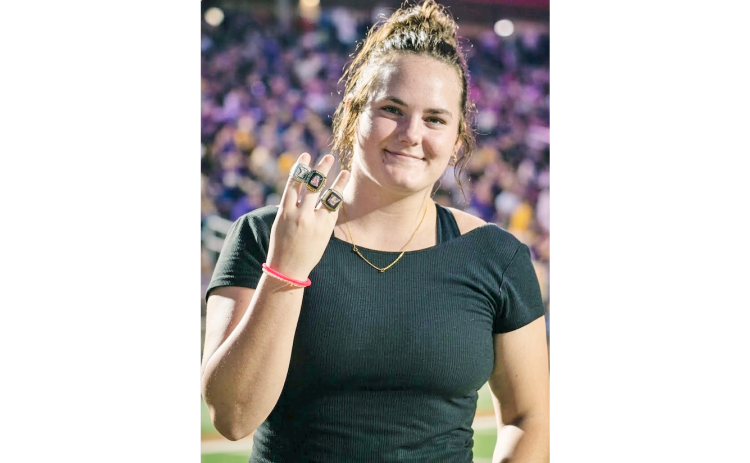 Lumpkin wrestler and State Champion Faith Jones shows off her State rings.