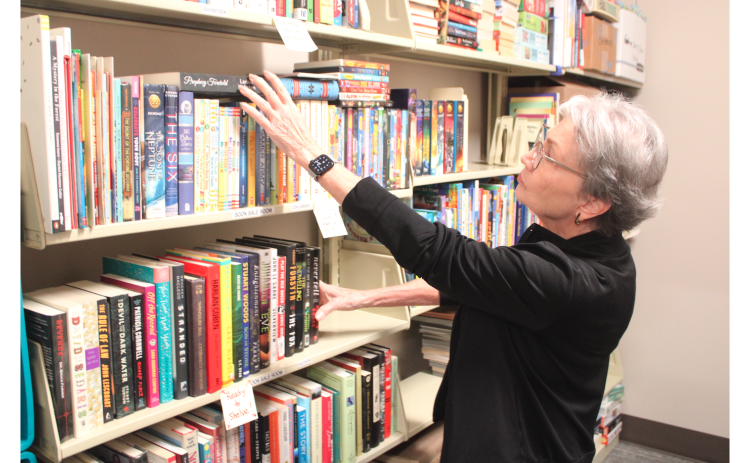 Lumpkin County Library volunteer Pat Gawthrop sorts new donations inside the Bargain Book Store’s processing room. Located just inside the library foyer, the store offers new and gently-used books, media, puzzles and games at affordable prices.