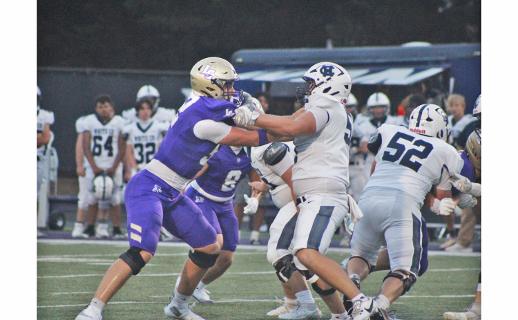 Senior Caleb Soles locks up with a White County lineman during last week’s game.