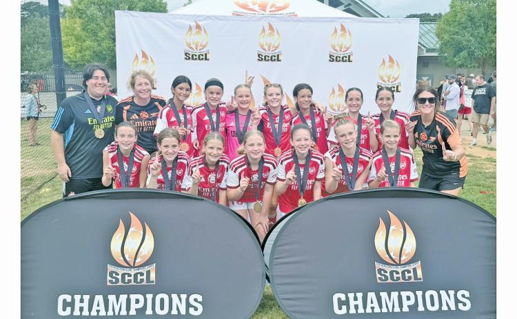 UFA Mountains U13G Academy celebrates their championship win.