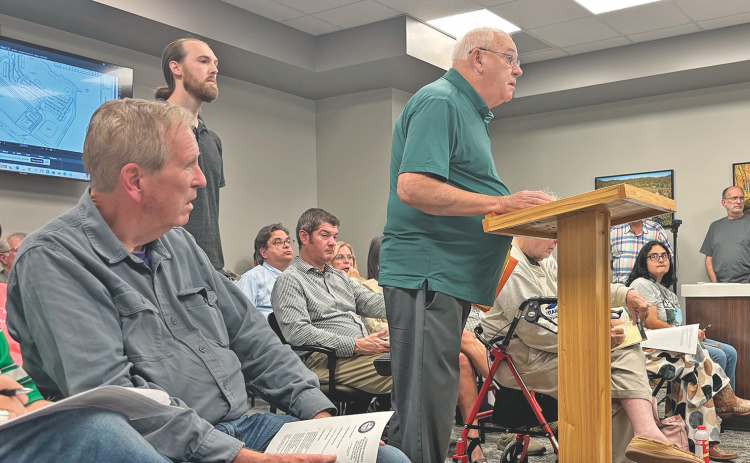 Project engineer Dave English addresses the Lumpkin County Planning Commission in a packed meeting room last Monday.  A development deemed Legends at Chestatee would bring a 272-unit apartment complex and more to the end of Highway 400, if approved as is.